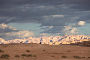 riders in a landscape of Al Ula in Saudi arabia