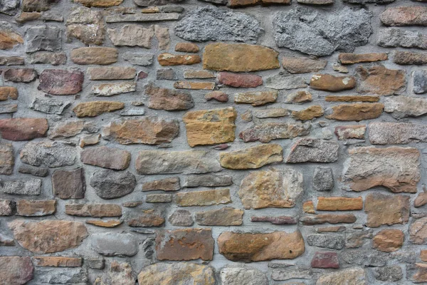 Arka Plan Olarak Renkli Taşlardan Yapılmış Eski Bir Duvar Eski — Stok fotoğraf