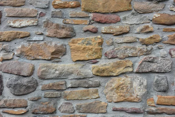 Arkaplan Olarak Renkli Taşlardan Yapılmış Eski Bir Duvar — Stok fotoğraf