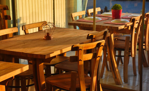 Empty tables and chairs in a Aegean Island restaurant. 