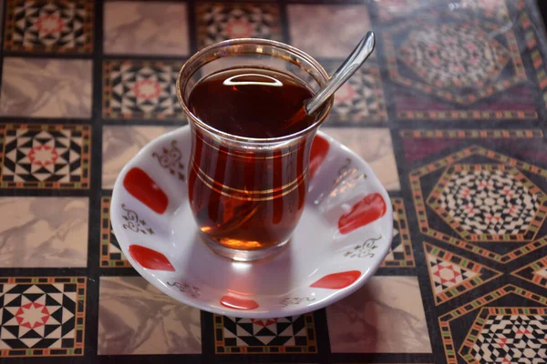 バックギャモンテーブルの上にトルコ茶とスプーンのガラス — ストック写真