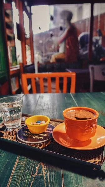 一杯土耳其咖啡放在绿色木制桌子上的盘子里 一杯水 土耳其喜欢吃一个小瓷盘 — 图库照片