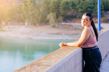 Teenager looking at the camera from a natural setting.