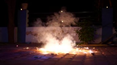 Süper yavaş çekim videosu, havai fişek patlatarak festivalin tadını çıkaran çocuklar. Yerde dönen çakra ya da çakri olarak bilinen kraker türü.