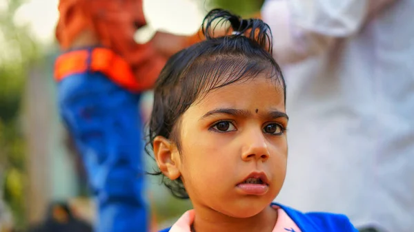 Innocent Indian Little Girl Wearing Blue Sweater Looking Camera Curly Royalty Free Stock Images