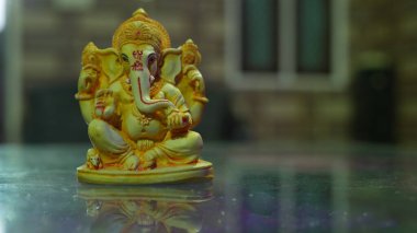 Happy Ganesh Chaturthi festival, Lord Ganesha statue with beautiful tiles background, Ganesh is hindu god of Success.