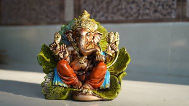 Happy Ganesh Chaturthi festival, Lord Ganesha statue with beautiful tiles background, Ganesh is hindu god of Success.