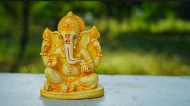 Eco friendly Ganesh or Ganpati idol or murti with nature background, home made. selective focus. Ganesha chaturthi festival 2022.