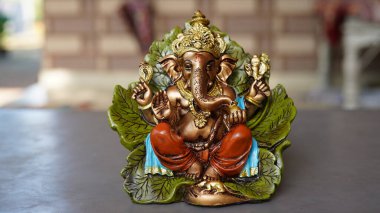 Golden lord ganesha sclupture over home background. celebrate lord ganesha festival.