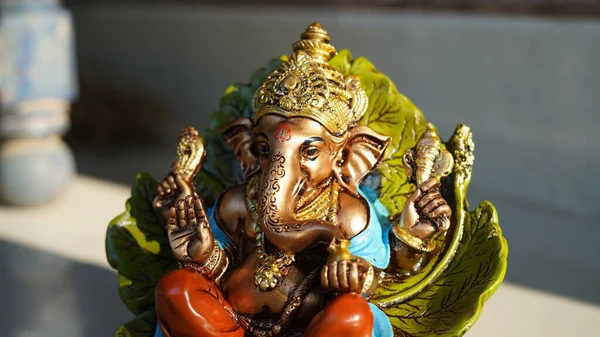 Happy Ganesh Chaturthi festival, Lord Ganesha statue with beautiful tiles background, Ganesh is hindu god of Success.
