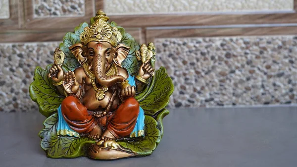 Beautiful Ganesha idol against decorative background. Clear space for text on the poster or greeting card for Ganesh Festival.