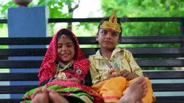 Children dress as Hindu deity Krishna and his consort Radha during the Janmashtami festival. Radha krishana swinging footage