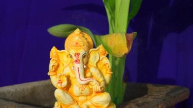 Golden lord ganesha sculpture on home background. People celebrate lord ganesha festival.