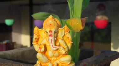 Water splash on lord ganesha sculpture. celebrate lord ganesha festival 2022. Slow motion footage
