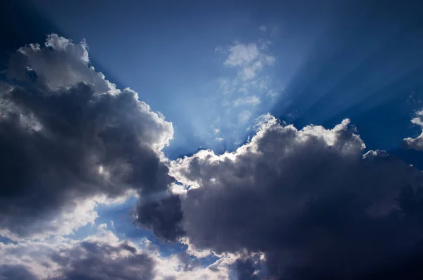 Blue sky with clouds and sun rays