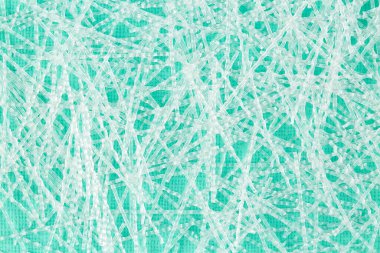 Kapatın, tepe rengi yüzeydeki beton yapısal takviye için dağınık sinüzoidal polipropilen liflerinin yukarıdan aşağı görüntüsü. İnşaat sektörü arka plan dokusu. 