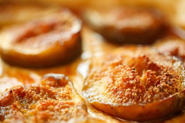 Extreme close up of half sliced, freshly backed figs with cinnamon. Autumn colors concept. Selective focus, very shallow DOF
