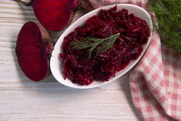 grated fresh beet on wooden background