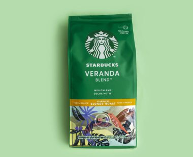 May 15 2022 Ukraine, the city of Kyiv a pack of coffee from the company Starbucks on a colored background