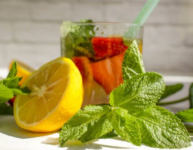 Çilekli limonata, nane, arka planda limon.