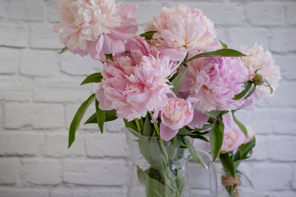 Beautiful peony flower in a vase on an old background