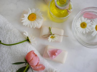 Sabun kozmetik çiçeği papatya çayı, hafif arka planda şakayık.