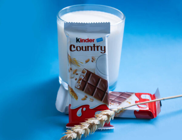 May 26, 2022 Ukraine city Kyiv Kinder chocolate from Ferrero, a glass of milk