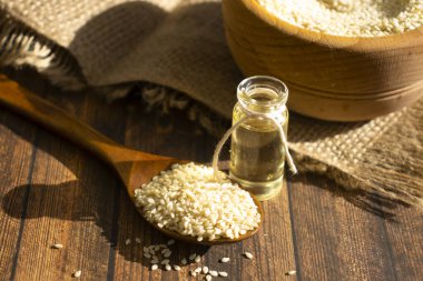 Sesame seeds spoon on old background