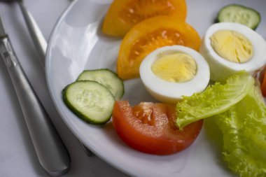 Boiled egg, tomato, lettuce on a diet plate