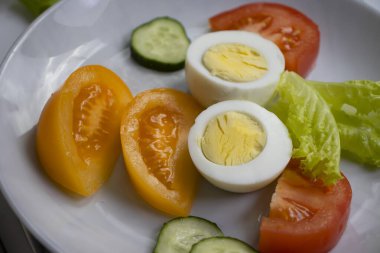 Boiled egg, tomato, lettuce on a diet plate
