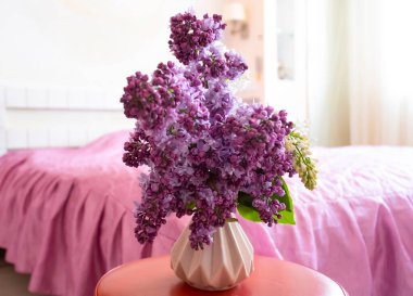 Beautiful bouquet of blooming lilacs in the room