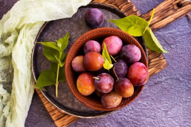Ripe plum on old background