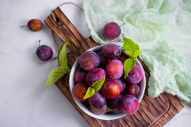 Ripe plum on old background
