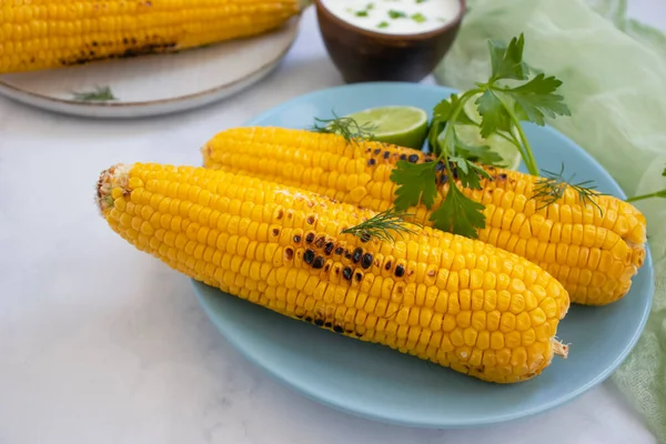 Fried corn, lime on a light background