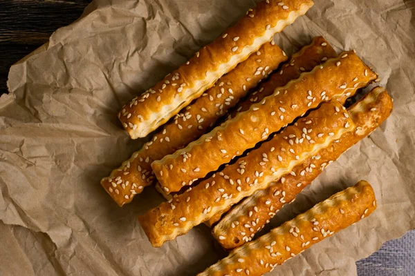 bread sticks with sesame seeds on old background