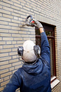 House insulation by injecting microbead pearls in the cavity walls clipart