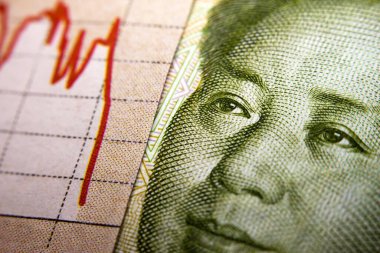 Stock market declining chart and Yuan banknote