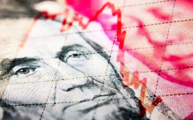 Stock market declining chart and US dollar and Chinese Yuan banknote