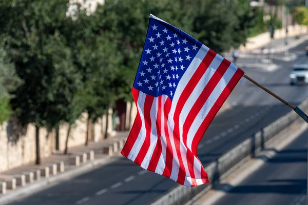 american flag waving in blue sky. American flag on the streets of Jerusalem