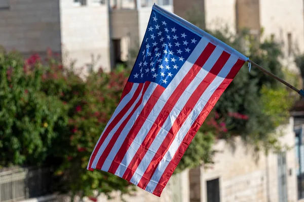 american flag waving in blue sky. American flag on the streets of Jerusalem