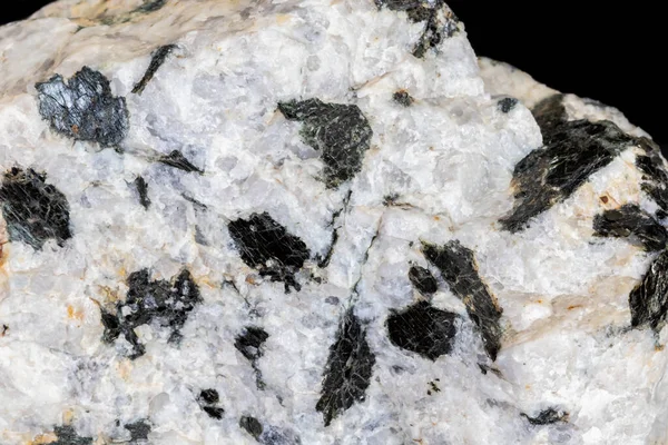 Pegmatite granite from central Arizona. Large black biotite mica crystals against white quartz. Photographed on black background.