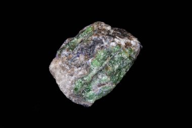Green Tsavorite garnet, rough samples on host rock from Tanzania. Total specimen weight 142 grams. Black background.