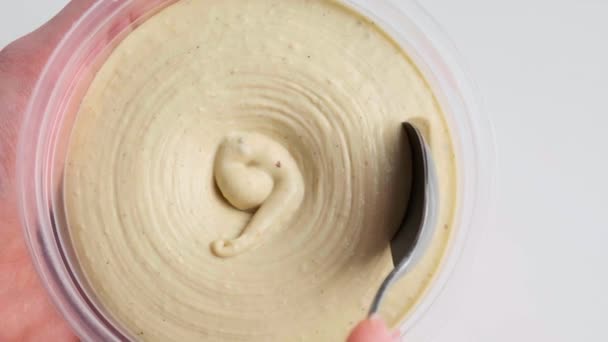 Eating hummus with a spoon, close-up. — Stock Video
