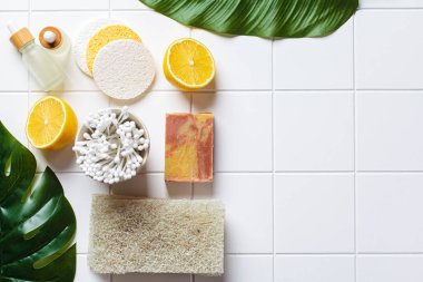Eco bath accessories. Natural brushes, soap, sponges and organic skin care products. White bathroom background, copy space, top view. Zero waste concept.