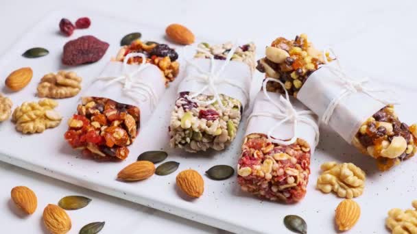 Energy granola bars with different seeds, nuts and dried fruits and berries. — Video