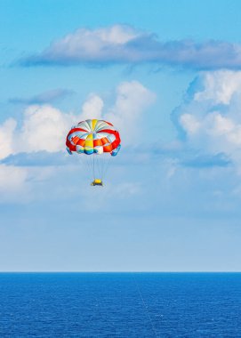 Parasailing towed behind a boat in the Caribbean sea, tropical Ocean, Vacation Concept, Cancun, Mexico.