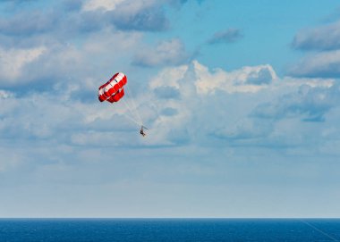 Parasailing towed behind a boat in the Caribbean sea, tropical Ocean, Vacation Concept, Cancun, Mexico.