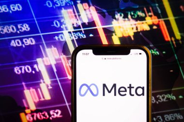 KONSKIE, POLAND - August 07, 2022: Smartphone displaying logo of Meta Platforms Inc on stock exchange diagram background
