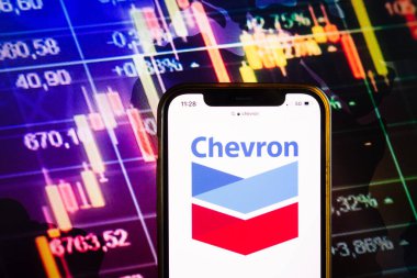 KONSKIE, POLAND - August 07, 2022: Smartphone displaying logo of Chevron Corporation on stock exchange diagram background