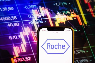 KONSKIE, POLAND - August 07, 2022: Smartphone displaying logo of F. Hoffmann-La Roche AG on stock exchange diagram background